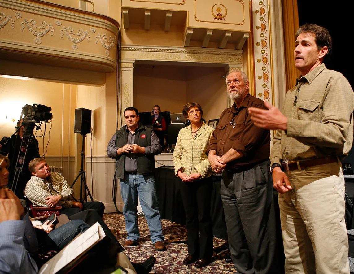 Speakers and audience during a panel discussion, photographed from the floor
